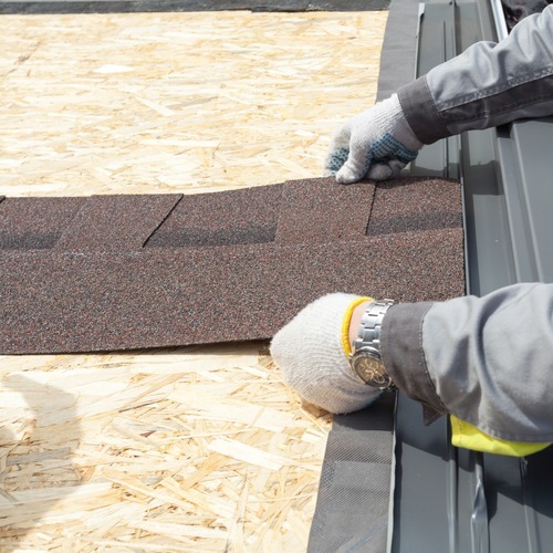 close-up of shingles being installed