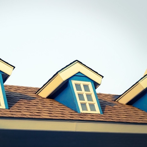 blue windows on a brown shingle roof