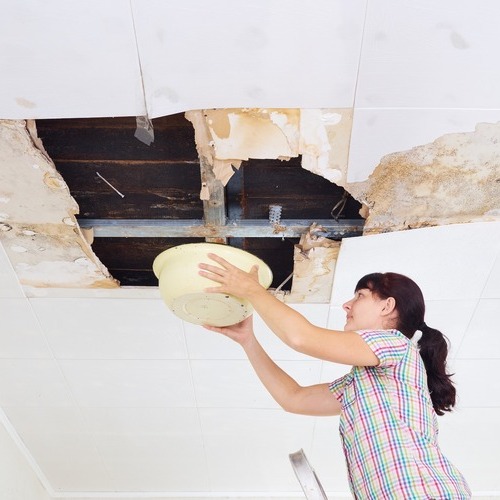 young woman dealing with a leaking roof